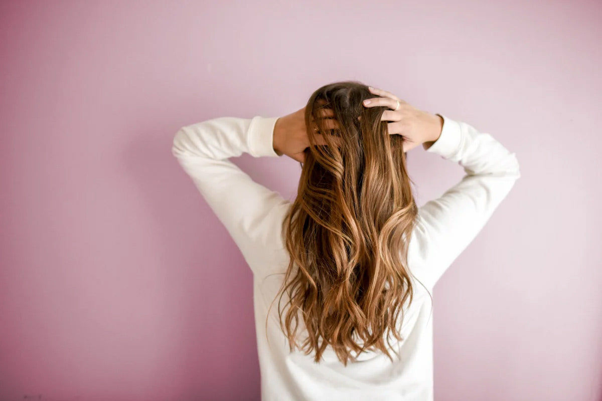 woman applying hair perfume