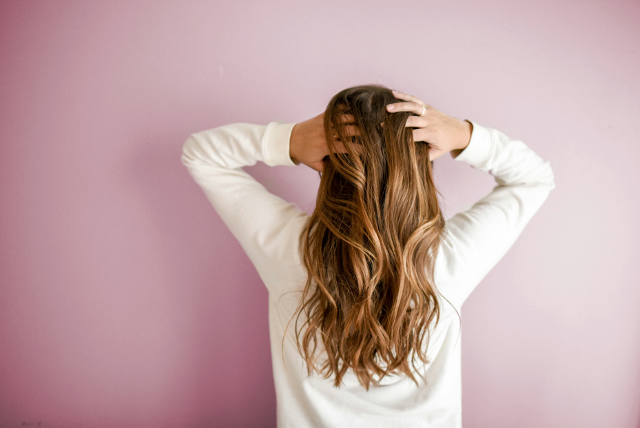 woman brushing frizzy hair